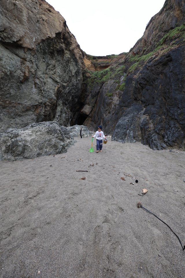 Young Explorer in a Rocky Coastal Canyon