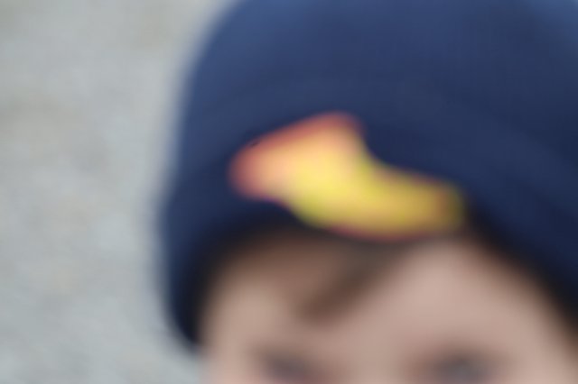 Blurred Close-Up of Child in Navy Baseball Cap