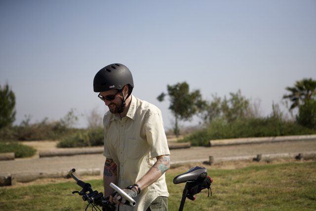 Man on a Bicycle Wearing a Protective Helmet