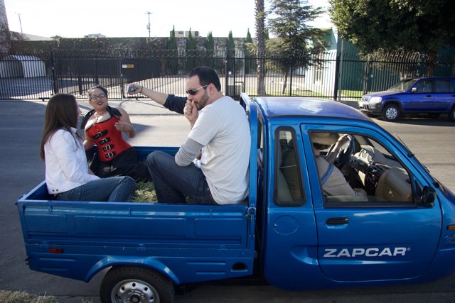 Blue Pickup Truck with Passengers