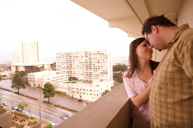 Couple Sharing an Intimate Moment on City Balcony