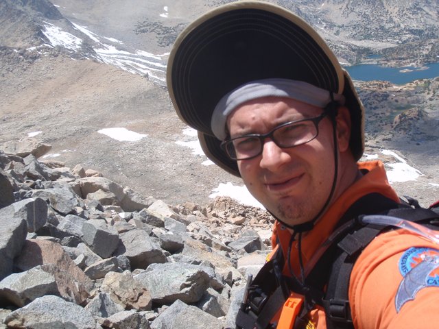 Hat-clad adventurer explores the mountain range