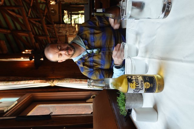 Man Enjoying Corona Beer at Rustic Restaurant