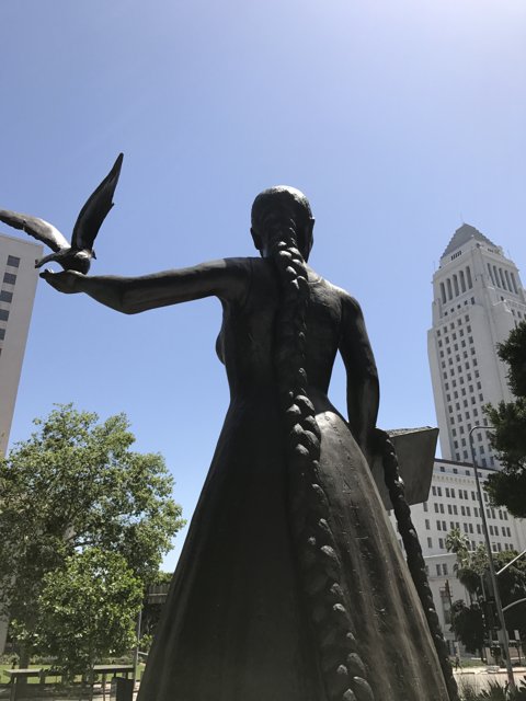 Statue of woman holding bird in Metropolis