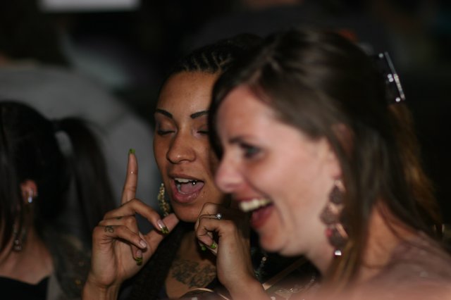 Two Women Laughing Together at Nightclub Event