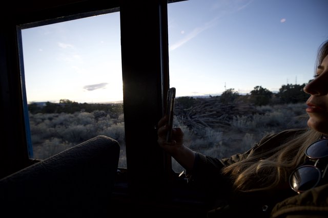Woman Gazing at Desert Sunset Through Vehicle Window