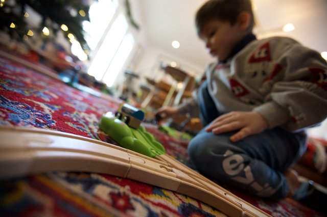 Child Playing with Train Set on Christmas Day