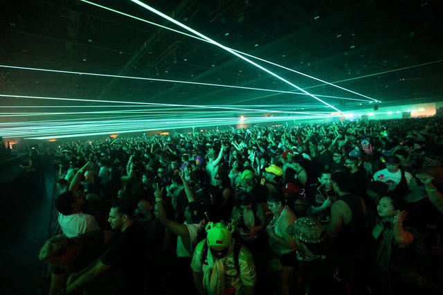 Green Laser Light Show Over Dancing Festival Crowd