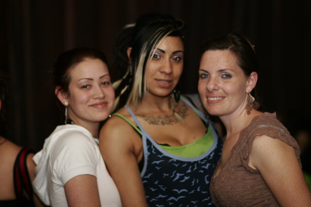Three Friends Posing at a Nightclub Anniversary Party