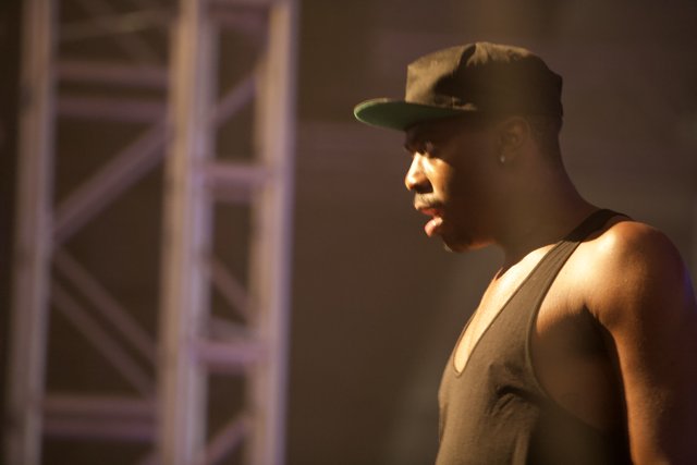 Man in Black Tank Top and Hat Takes the Stage at Coachella 2012