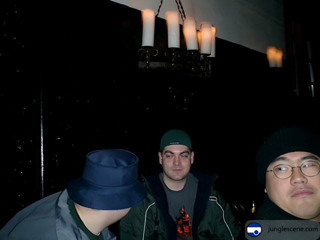 Three Men in a Dark Room with Candles