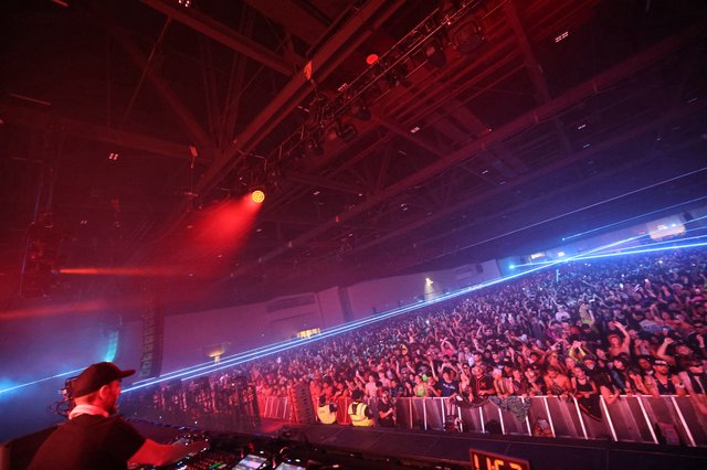 Massive Crowd Ignites Under Laser Light Storm