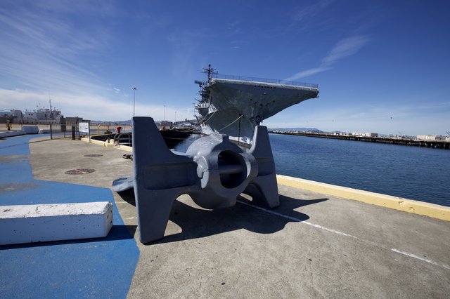 Naval Anchor and Aircraft Carrier at Harbor