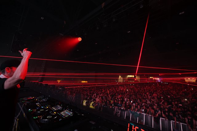 DJ Ignites the Crowd with Blazing Red Lasers