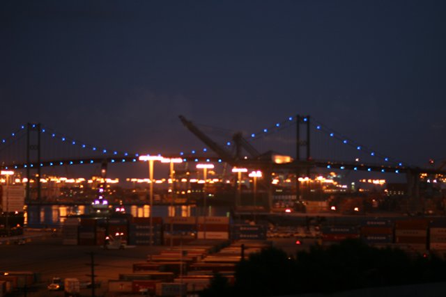 Illuminated Bridge over Urban Waterfront