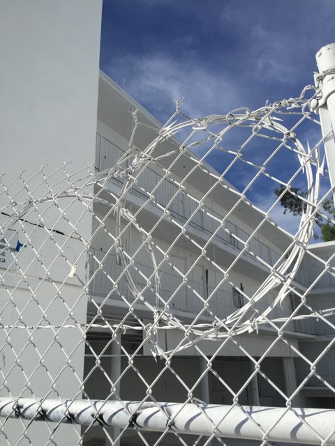 White Building with Fence and Sign in Los Angeles