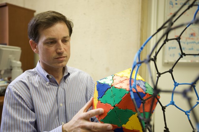 Multi-Colored Sphere in the Hands of a Man