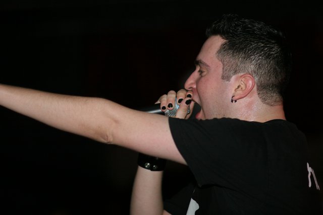 Black Shirted Entertainer with a Microphone