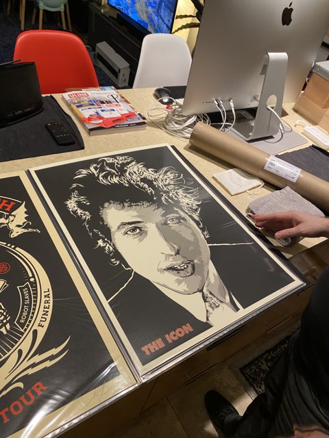Ezra Miller Observing Posters on a Desk