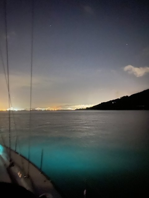 Night Sailing Beneath a City Skyline