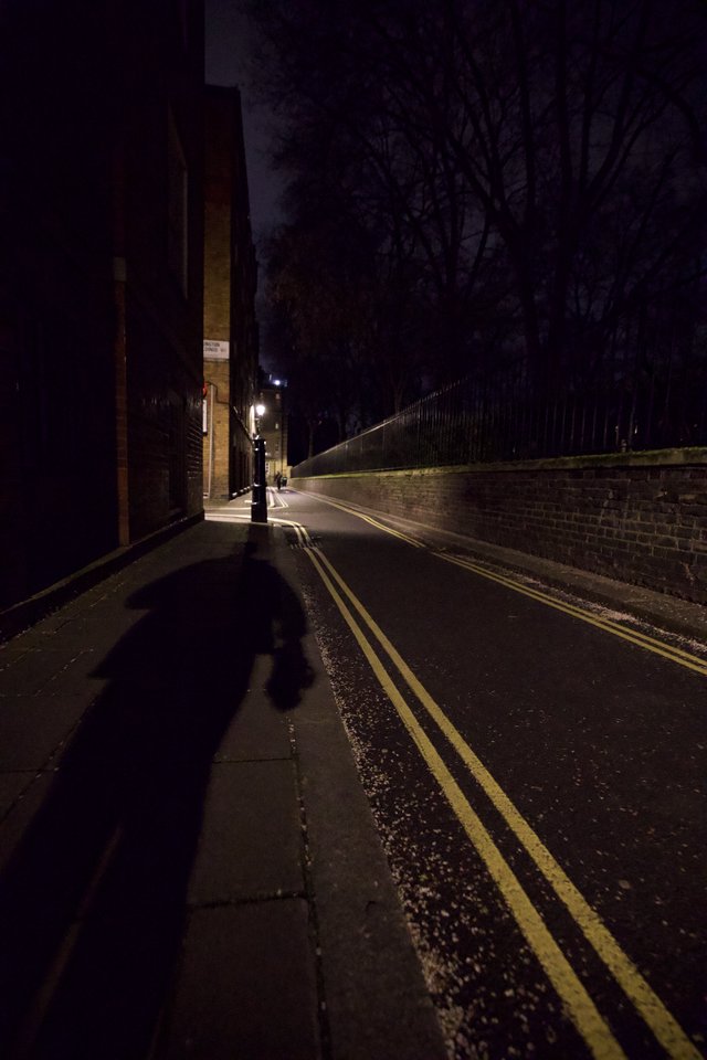 Shadow Figure on Empty London Street at Night