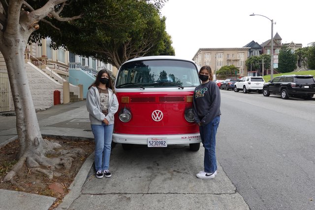 Friends Posing with Classic Red Volkswagen Van