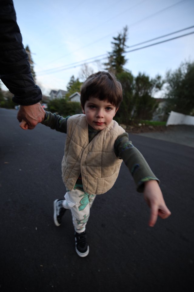 Child's Joyful Evening Walk in Suburban Neighborhood