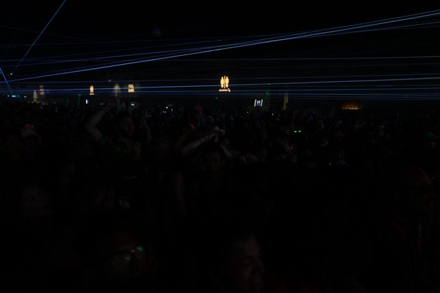 Electric Blue Laser Grid Over Dark Festival Crowd