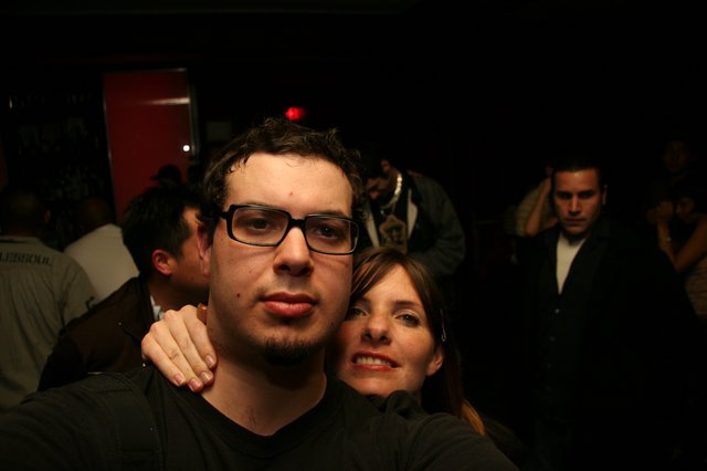 Two Friends Pose at a Dimly Lit Nightclub
