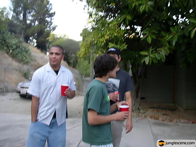 Three young men enjoying drinks outside