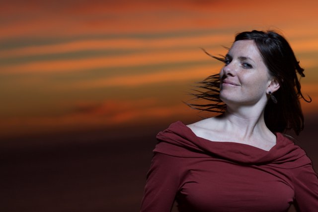 Woman in Red Against a Fiery Sunset Sky