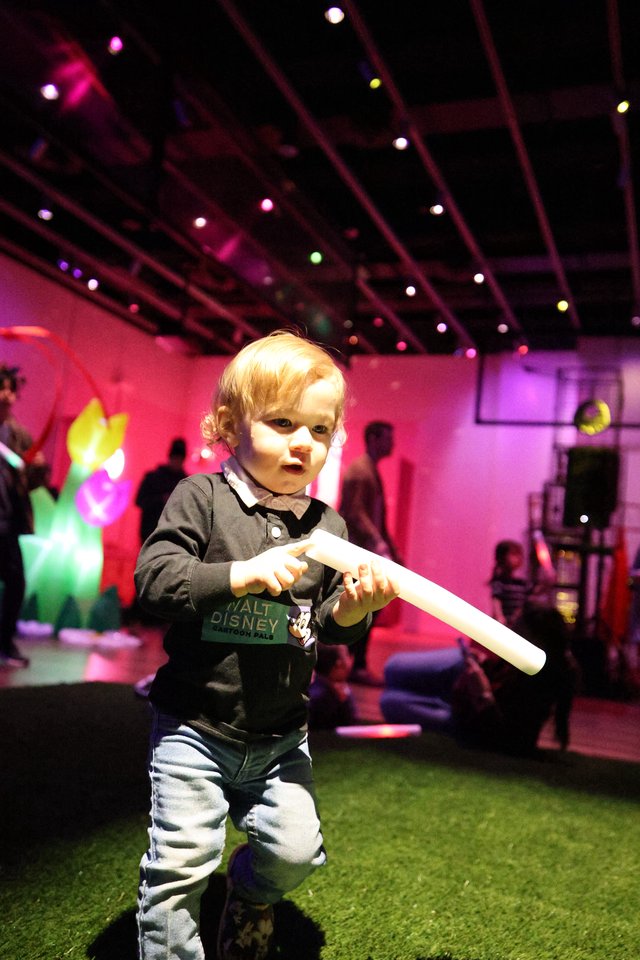 Toddler with Light Stick at Baby Rave Event