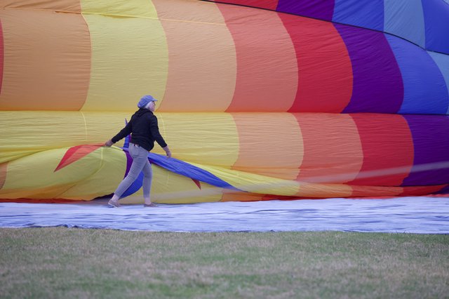 Ground Crew Wrestles Rainbow Balloon Into Life