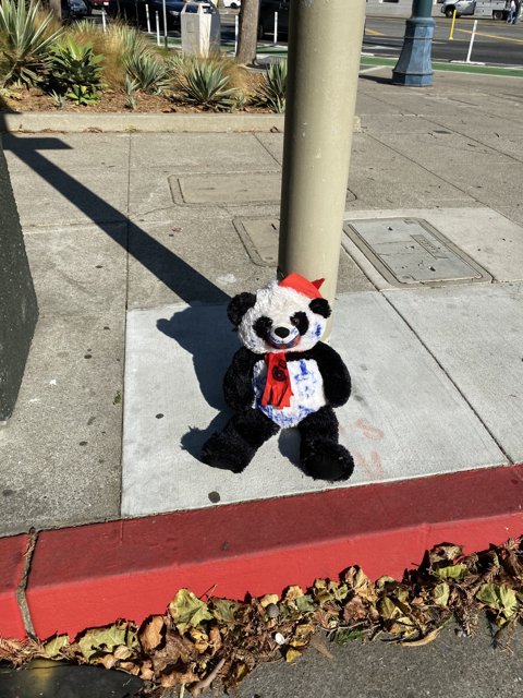 Plush Panda on the Sidewalk