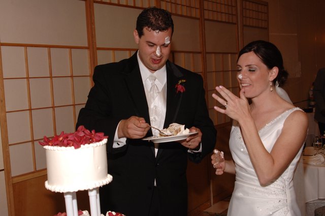 Bride and Groom Smeared with Wedding Cake Frosting