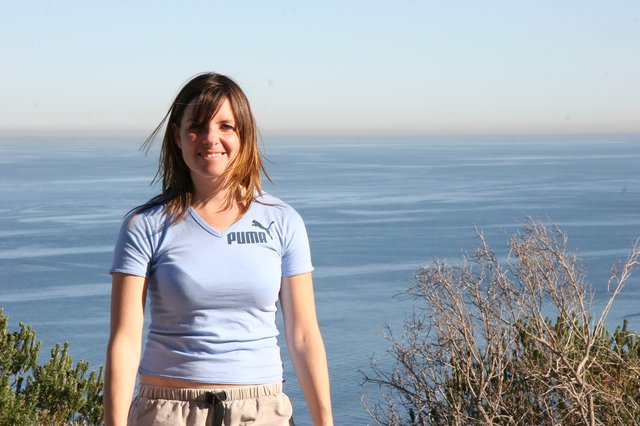 Smiling Woman at Coastal Overlook with Ocean View