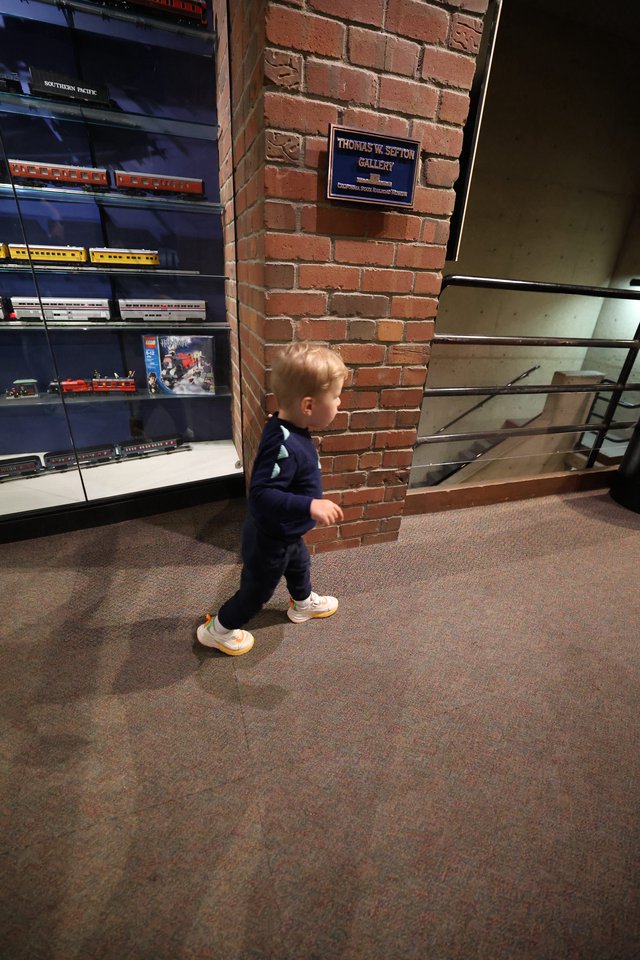 Young Child Exploring Railroad Museum Gallery