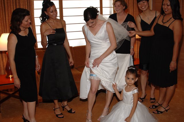 Bride Shows Off Wedding Garter with Bridesmaids
