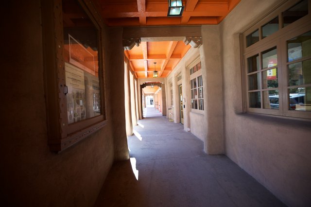 Sunlit Adobe Corridor with Wooden Beam Ceiling in Santa Fe