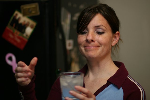 Woman Gives Thumbs Up with Iced Drink