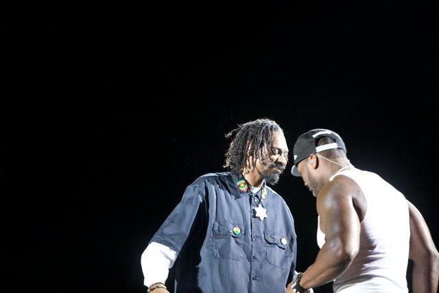 Two Men on Stage with Snoop Dogg