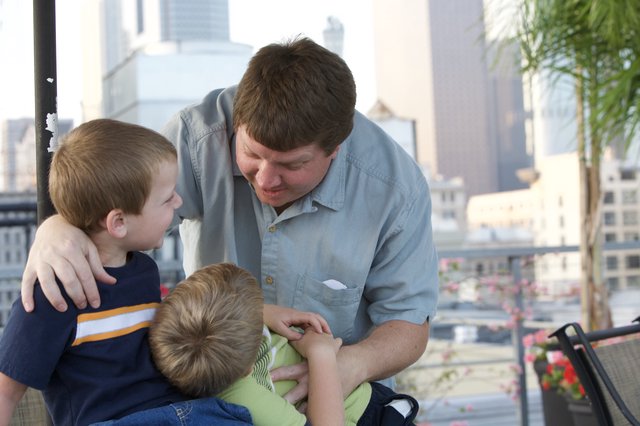 Father Shares Tender Moment With Two Young Sons