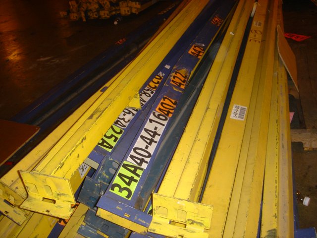 A Pile of Yellow Steel Bars on a Pallet