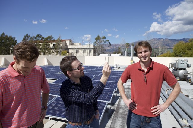 Three Men Working on Solar Panels