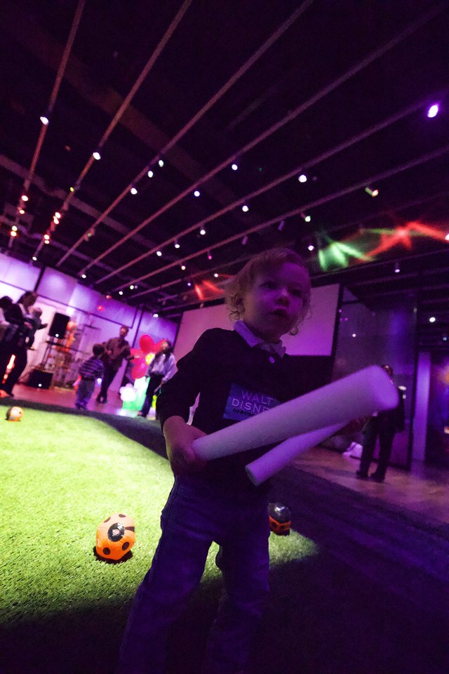 Toddler Dancing at Baby Rave Event with Purple Lights