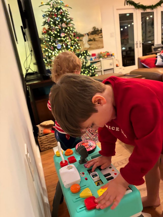 Children Playing with Activity Toy on Christmas Morning