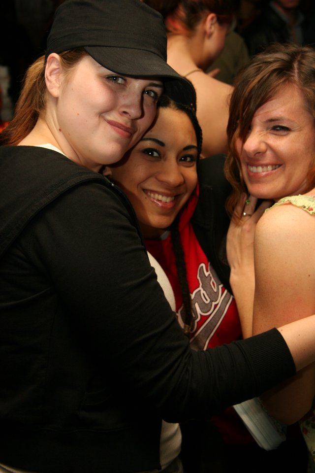 Three Friends Share a Joyful Group Hug