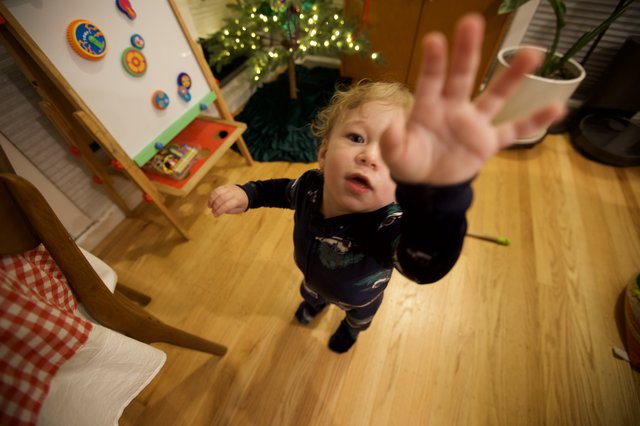 Toddler Reaching Toward Camera on Christmas Morning