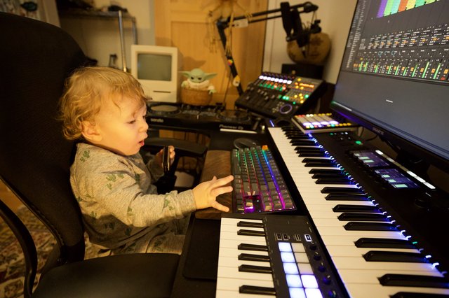 Young Child Exploring Music Production Studio Setup