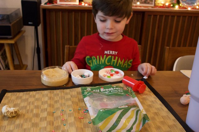 Child Crafting Christmas Ornaments with Dough Play Kit